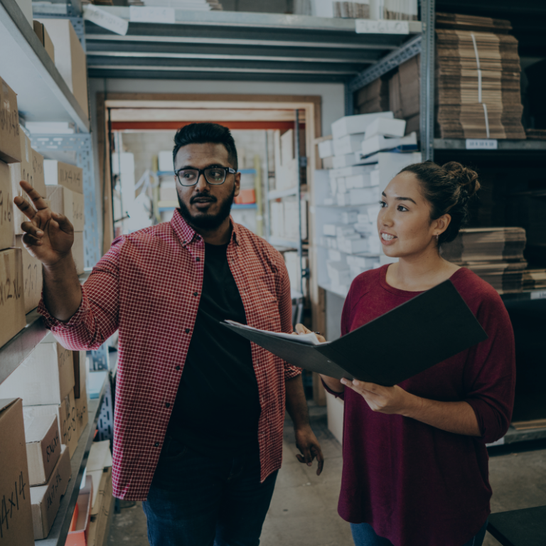 a man talking to a woman in a warehouse
