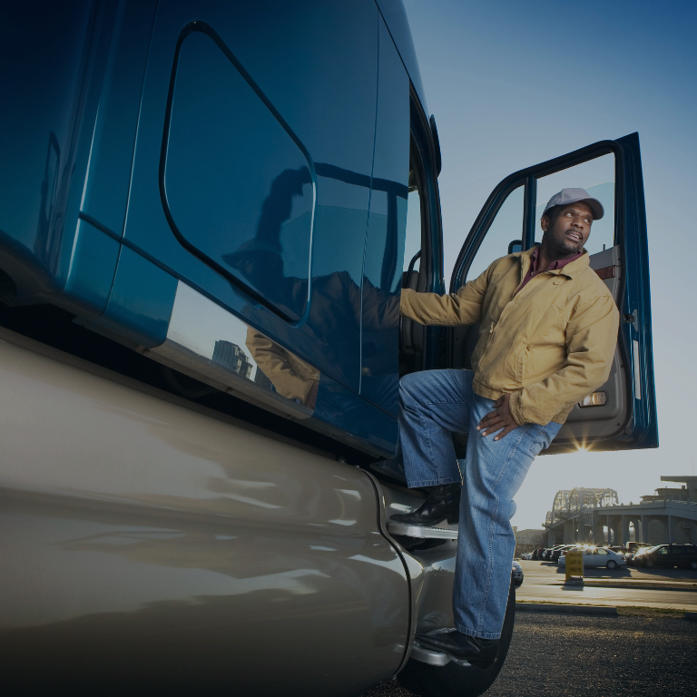 man standing in the door of a tractor-trailer